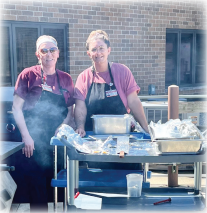Team members grilling for residents
