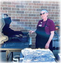 Staff member cooking on grill